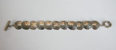 A boxed Silver Rennie Mackintosh Collection rose design articulated bracelet with loop and bar