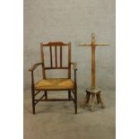 A 19th century mahogany framed splat back open arm chair with straw seat raised on tapering supports