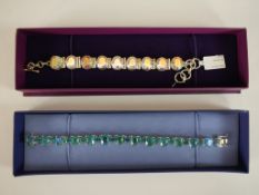 Two boxed silver and gem-set articulated bracelets, both set with mystic quartz, one green and one
