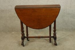 A 19th century mahogany dropleaf Sutherland table raised on splayed supports terminating in casters.