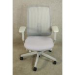 A contemporary Herman Miller adjustable office chair raised on five splayed supports terminating