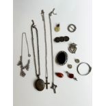 A collection of silver and costume jewellery, including a Victorian silver coin brooch, an amber