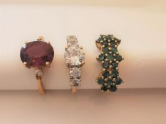Three 20th century 10 carat yellow gold gem-set rings: a tourmaline triple floral cluster ring, a
