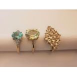 Three 20th century 10 carat yellow gold gem-set rings: a Prasiolite solitaire ring, a blue topaz