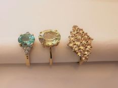 Three 20th century 10 carat yellow gold gem-set rings: a Prasiolite solitaire ring, a blue topaz