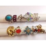 A collection of ten silver and gold plated silver dress rings set with various gemstones,