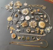 A large collection of costume jewellery, to include various silver charms, paste set brooches and