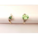 Two 20th century 18 carat yellow gold gem-set rings: a flanked solitaire dress ring set with a green