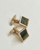 A pair of 1980's 9 carat yellow gold and tigers eye inlaid cufflinks. The cufflinks with hinged