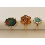 Three 20th century 10 carat white gold gem-set rings: a Citrine floral cluster ring, an ammolite