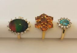 Three 20th century 10 carat white gold gem-set rings: a Citrine floral cluster ring, an ammolite