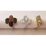 Three 20th century 10 carat gold gem-set rings: a floral design tourmaline and topaz dress ring, a