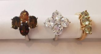 Three 20th century 10 carat gold gem-set rings: a floral design tourmaline and topaz dress ring, a