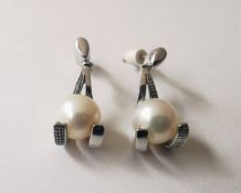 A pair of 20th century 18 carat white gold and white cultured pearl drop earrings, the earrings in