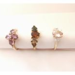 Three 20th century 10 carat gold gem-set rings: a flanked solitaire Morganite ring, a three stone