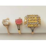 Three 20th century 9 carat gold gem-set rings: a ruby and diamond cross over ring, a Citrine and