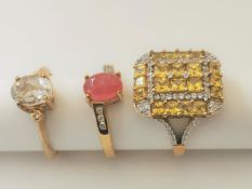 Three 20th century 9 carat gold gem-set rings: a ruby and diamond cross over ring, a Citrine and