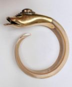 A 15 carat yellow gold and carved shell snake bangle. The gold head has an open mouth with tongue