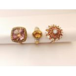 Three 20th century 9 carat gold gem-set rings: an orange and white sapphire sun design dress ring,