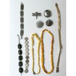 A collection of costume jewellery, including a green paste articulated bracelet, a pewter