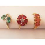 Three 20th century 9 carat and 10 carat yellow gold gem-set rings: a tourmaline and diamond cross