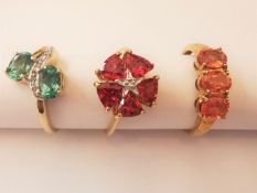 Three 20th century 9 carat and 10 carat yellow gold gem-set rings: a tourmaline and diamond cross