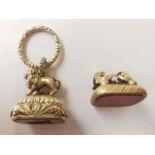 Two Victorian yellow metal plated fob seals, one with a carved lion finial and scrolling foliate