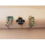 Three 20th century 10 carat white gold gem-set rings: a floral design sapphire ring, a blue topaz