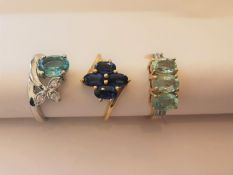 Three 20th century 10 carat white gold gem-set rings: a floral design sapphire ring, a blue topaz