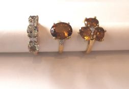 Three 20th century 10 carat yellow gold gem-set rings: a three stone Prasiolite dress ring, a