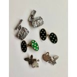 Three pairs of silver chain-link cufflinks. A pair gilded silver green and and white polka dot