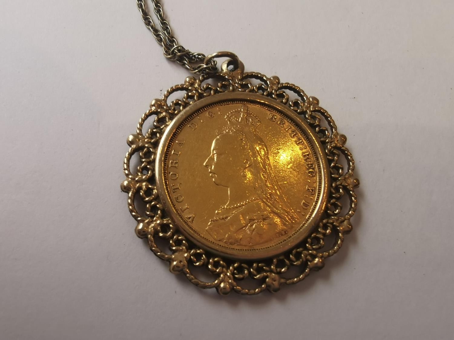 An 1889 Victorian full sovereign in filigree wirework mount on a 9 carat yellow gold rope chain. ( - Image 3 of 4