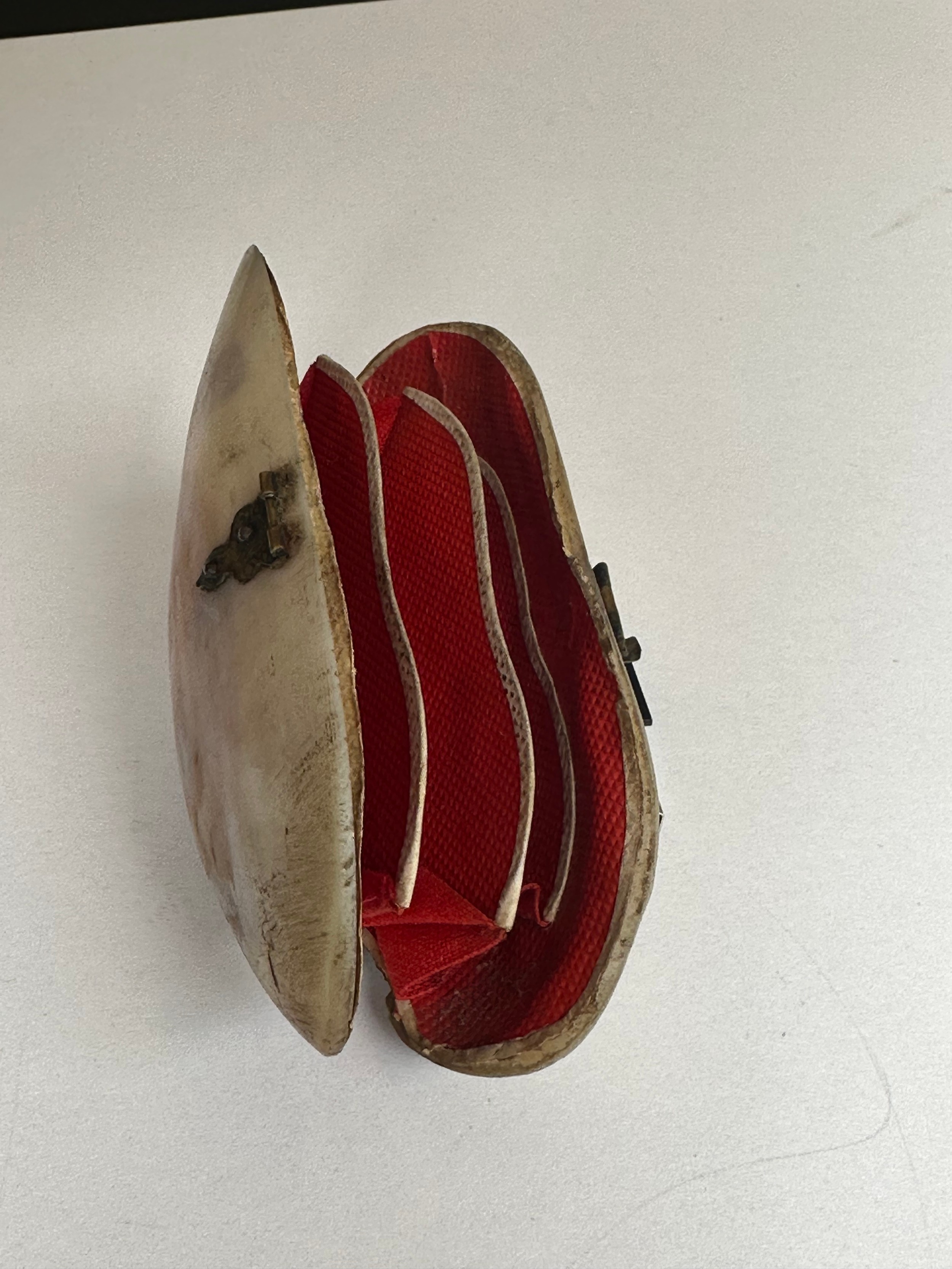 An early 20th century clam shell hinged purse with red lining along with a French miniature whistle. - Image 3 of 4