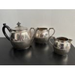 A Victorian three piece sterling silver gadrooned tea set to include tea pot, sugar bowl and milk
