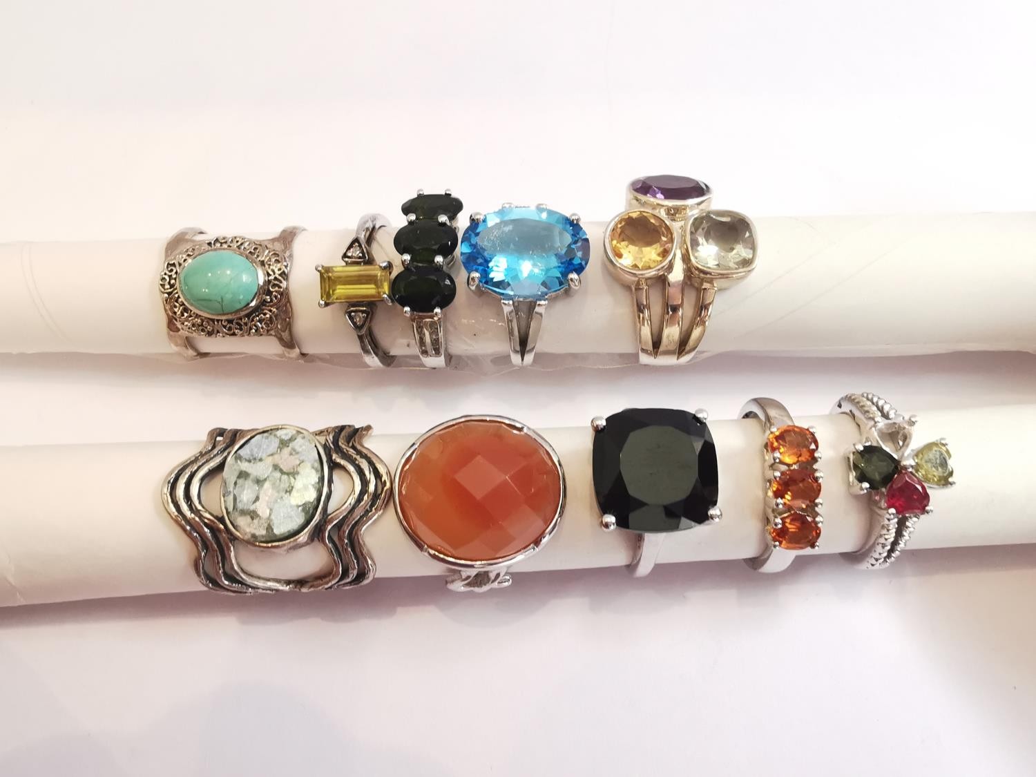 A collection of ten silver and gold plated silver dress rings set with various gemstones,