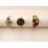 Three 20th century 10 carat gold gem-set rings: a green stone solitaire ring, a dress ring set