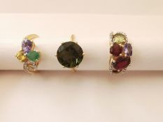 Three 20th century 10 carat gold gem-set rings: a green stone solitaire ring, a dress ring set