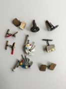 A collection of silver and pewter cufflinks, including a pair of pewter artists palette and brush