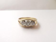 An 18ct yellow gold and white gold three stone diamond ring, set with three round brilliant cut