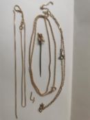 A collection of 9ct yellow gold various link chains and a 14ct gold wishing bone stick pin. (Two