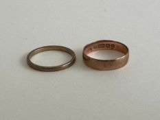 Two 9 carat gold wedding bands, a wide court shaped rose gold band and a slim yellow gold flat band.