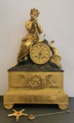An early 19th century French Neo Classical gilt metal and ormolu figural mantel clock, the