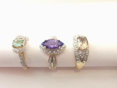 Three 20th century 18 carat yellow gold gem-set rings: a Marquise cluster ring set with Tanzanite