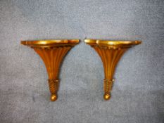 A pair of early 20th century gold painted shaped wall brackets. H.36 W.30 D.14cm