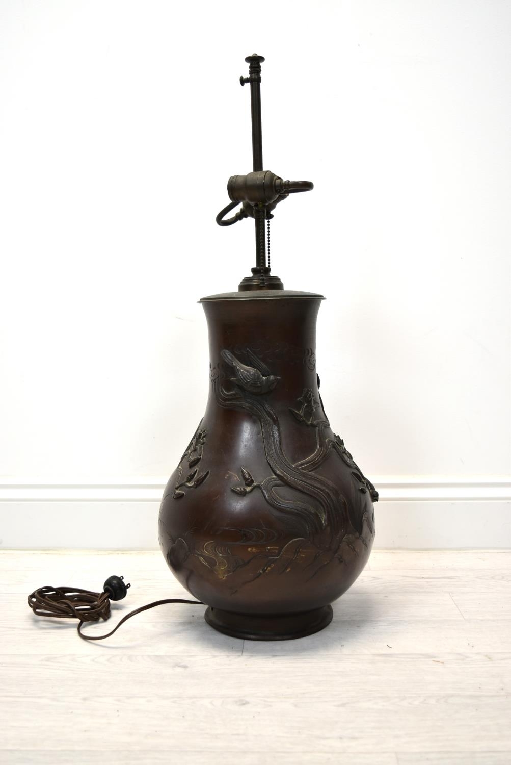 A Japanese Meiji period (1852-1912) bronze baluster vase cast with bird decoration (converted to a