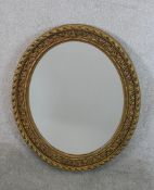 A contemporary gilt framed oval wall mirror. H.72 W.60cm