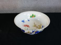 A 20th century Japanese porcelain bowl, the interior decorated with butterflies in a garden and