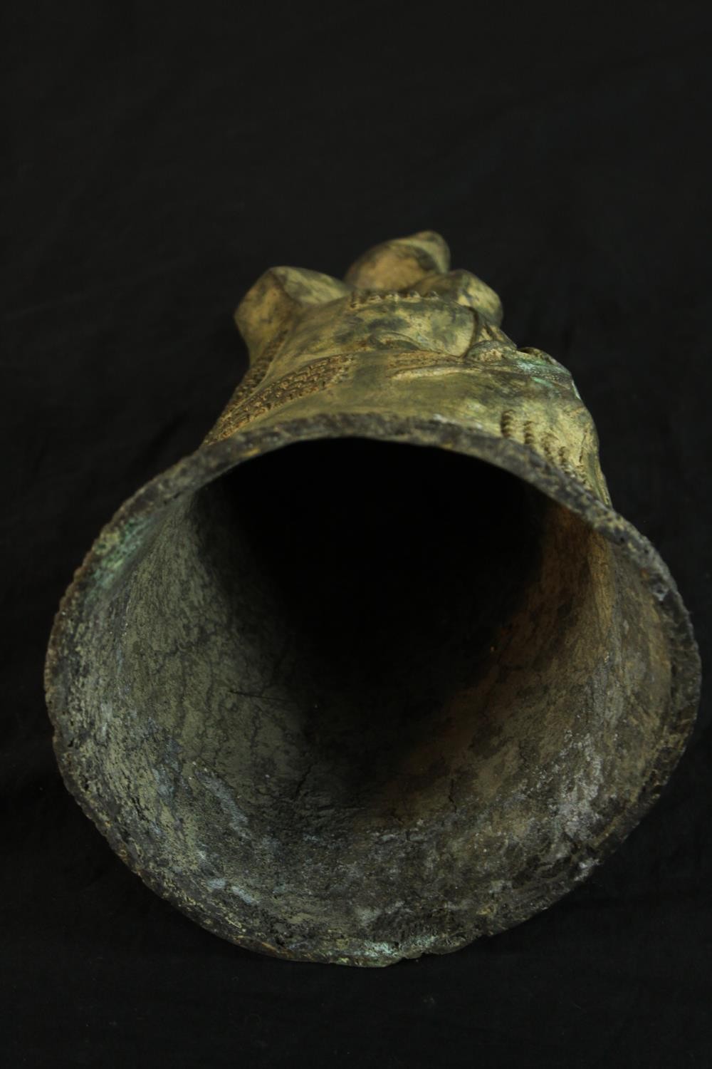 A Japanese possibly Edo period cast bronze bell modelled in the form of a stylised head. H.36cm. - Image 4 of 4