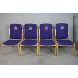 A set of four contemporary beech framed stacking chairs raised on tapering supports, each with