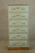 A Victorian style painted pine chest of six short drawers with turned knob handles raised on block
